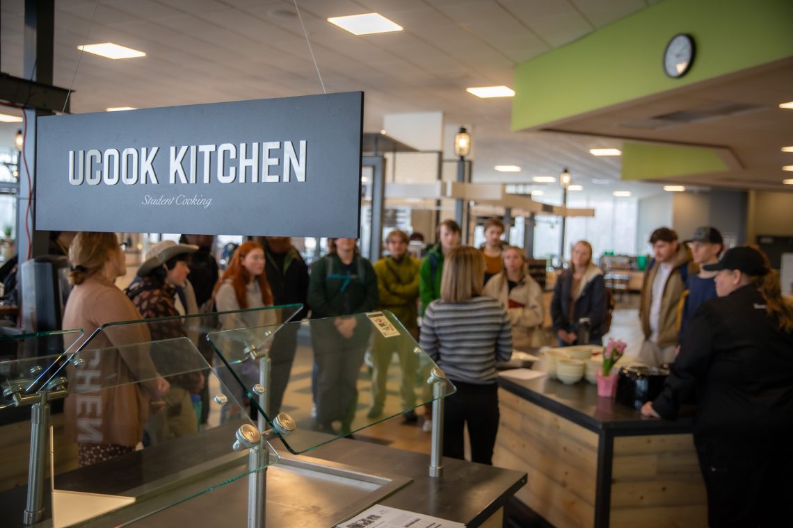 Students gather at the UCook Kitchen in Brooks Dining Hall for a Tasty Soultions cooking demo.