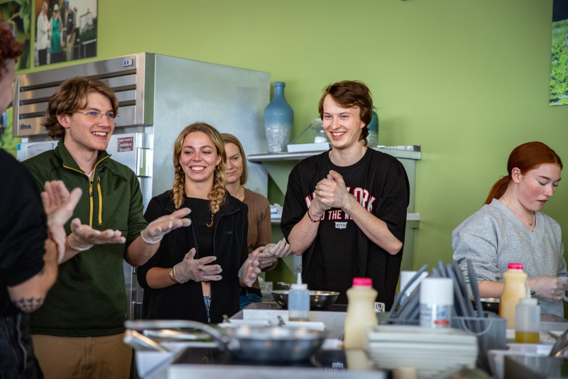 Students laughing and enjoying a cooking demonstration by Executive Chef Virginia Jordan.