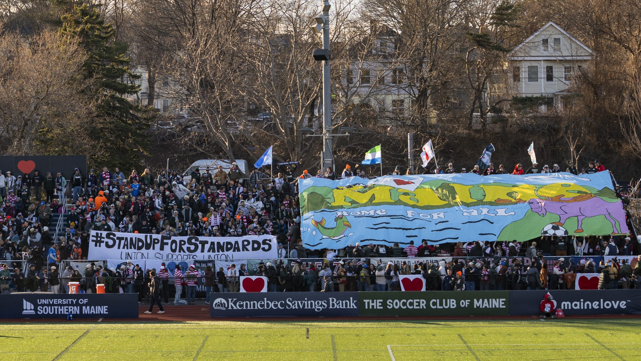 Fitzpatrick Stadium on a sunny day in Portland, Maine. The University of Southern Maine's logo can be read as a sponsor on the field-level boards.