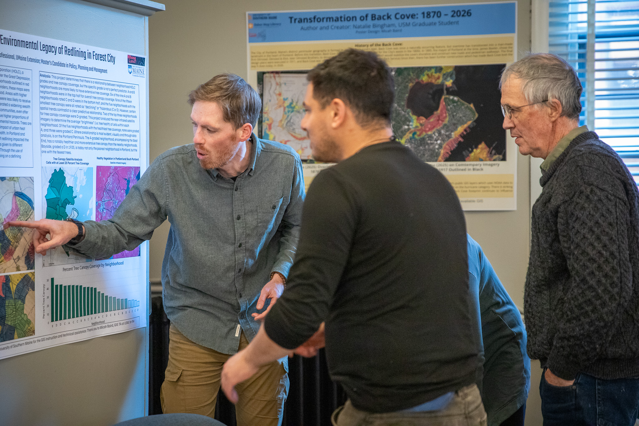 A GIS student talking through his map with attendees at First Friday Art Walk.