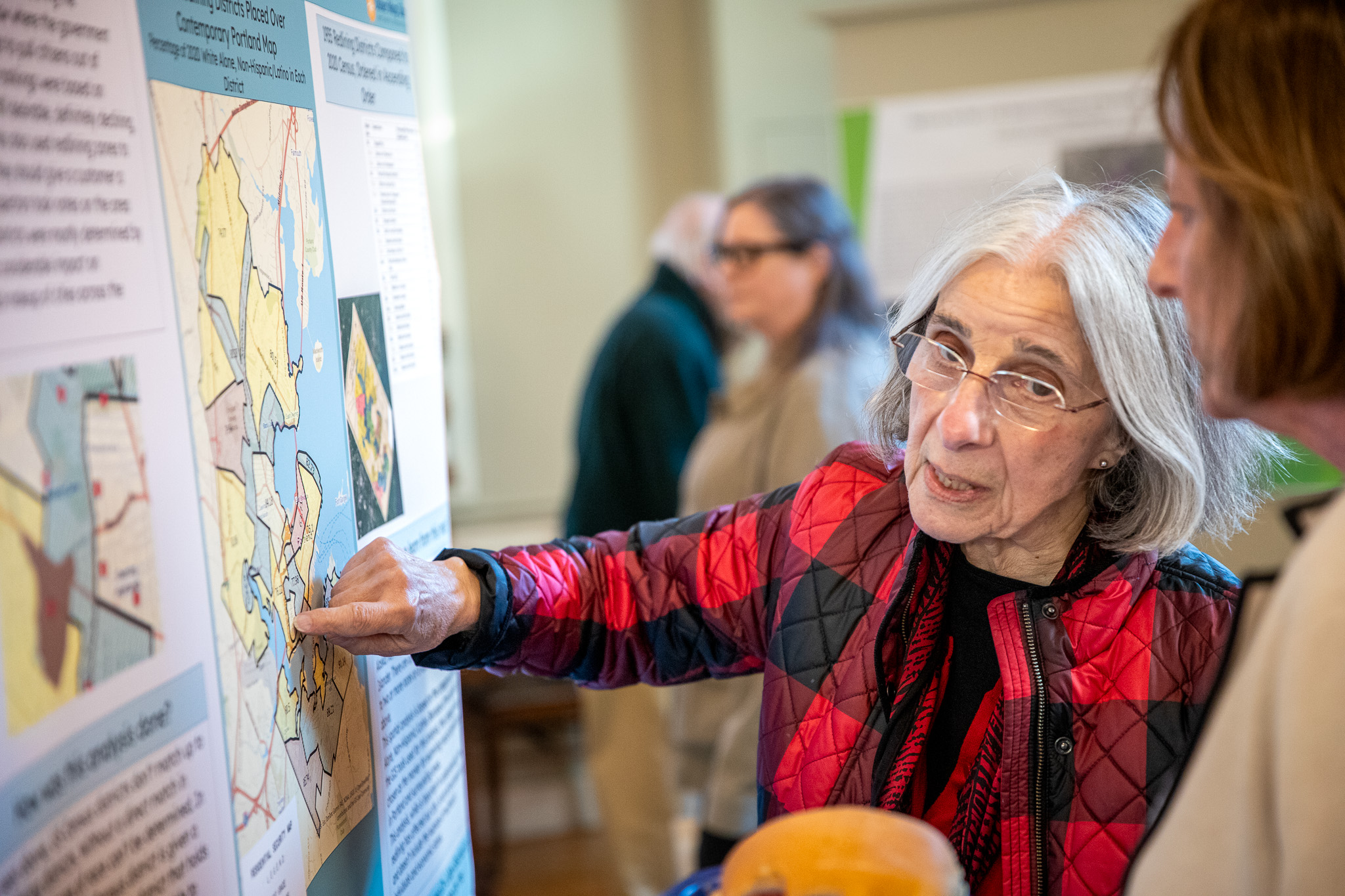 Attendee discussing the redlining map with a student.