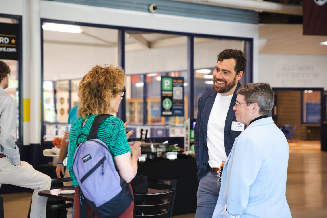 Andy Osheroff of USM smiles while talking with attendees at the "Good People, Great Connections" networking event in the Alumni Reception Center.