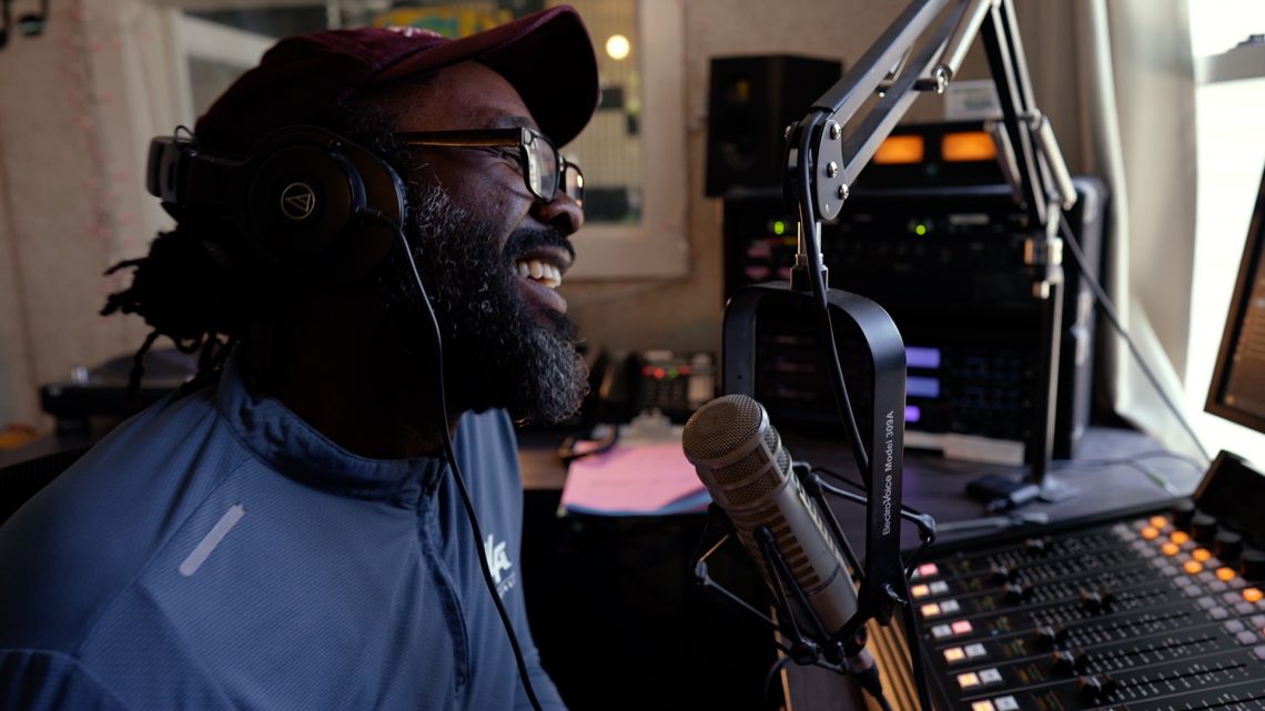 A still of a man DJing at WMPG from WMPG documentary "An Extraordinary Place".