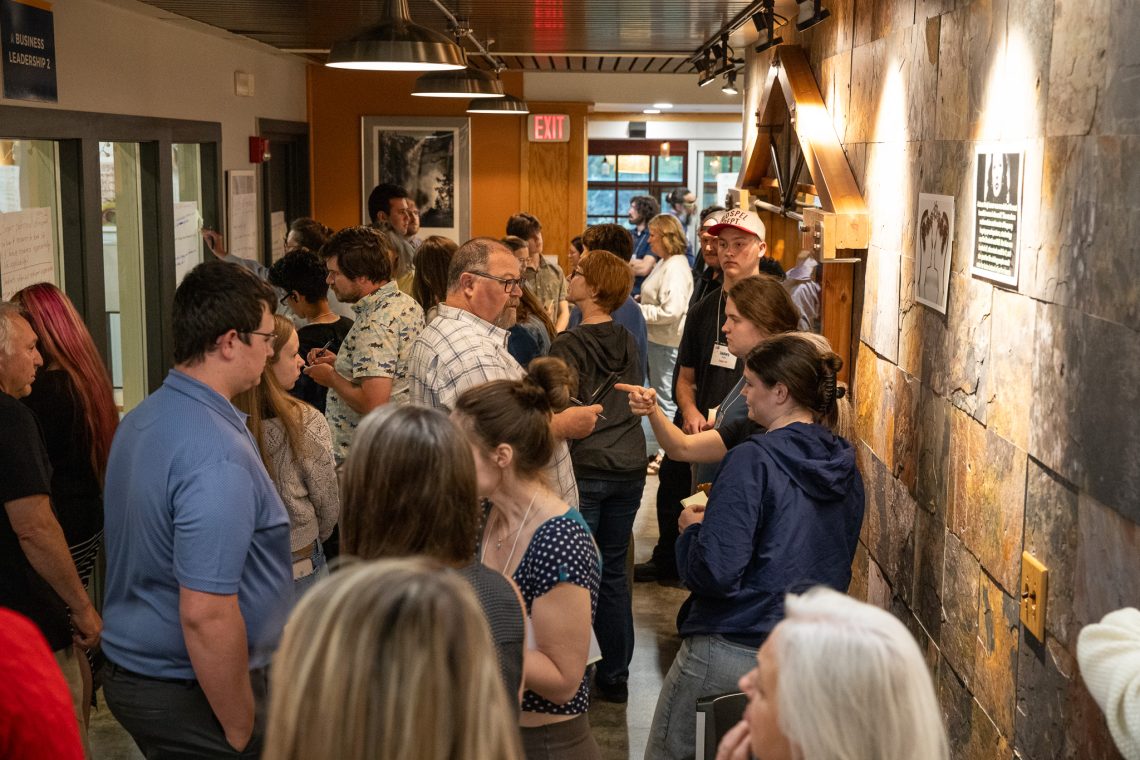 Delegates read draft proposals posted along a hallway wall and leave written feedback.