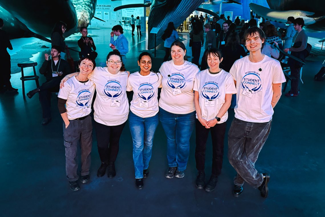 Six members of the International Graduate Student Research Cohort pose in matching Student Connect T-shirts at the Whales of Iceland museum in Reykjavik.