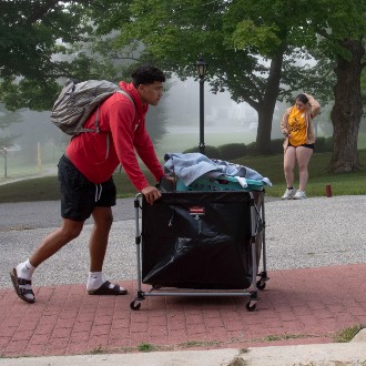 Gabe Galarraga pushes a cart filled with his belongings into his dorm at Robie-Andrews Hall.