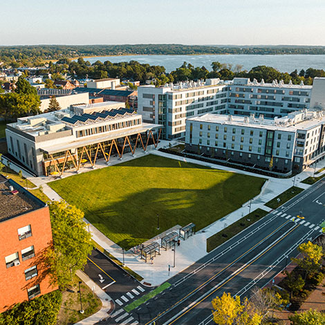 An aerial view that features our McGoldrick Center on the left and our Portland Commons residence hall on the right. Portland's Back Cove appears in the background.