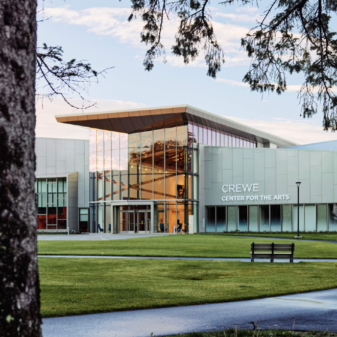 View of the Crewe Center for the Arts framed by tree branches on USM’s Portland campus.