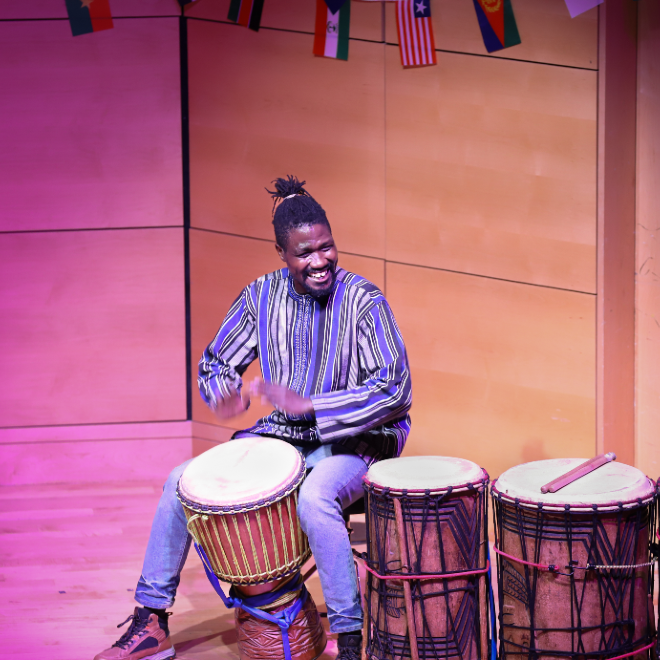 Performer in Afrochella plays the Djembe drum to open the show
