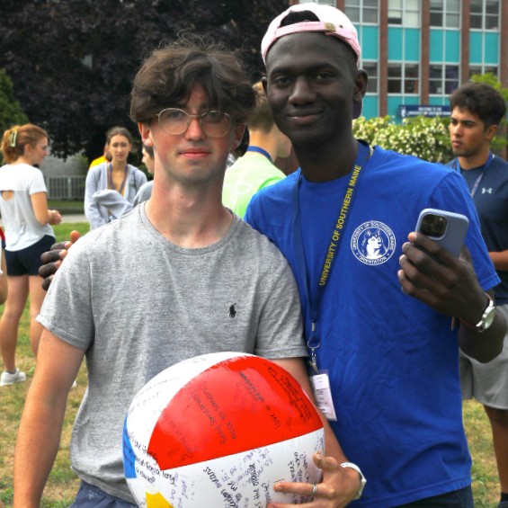 A pair of friends pause during ice breaker activities during fall 2022 opening weekend orientation.
