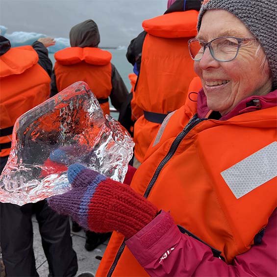 Woman hold up a large lump of transparent ice