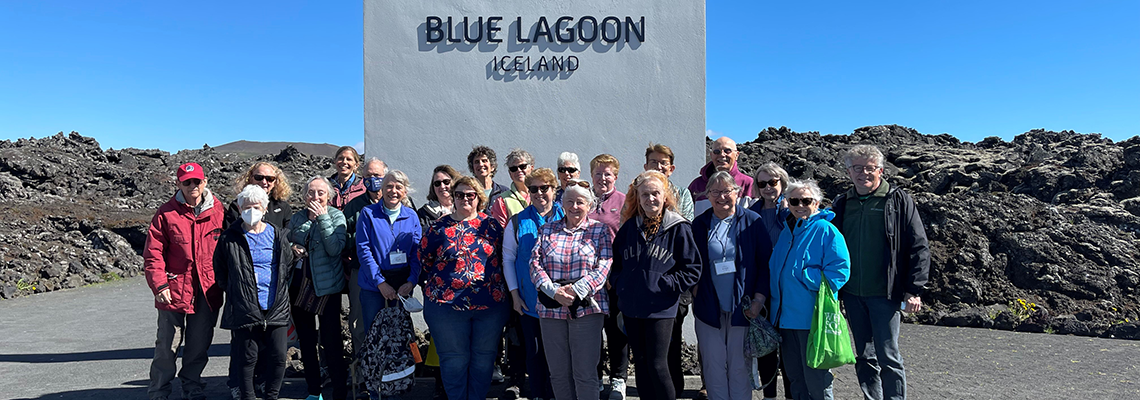 OLLI Travelers standing in a group in front of sign that say Blue Lagoon Iceland