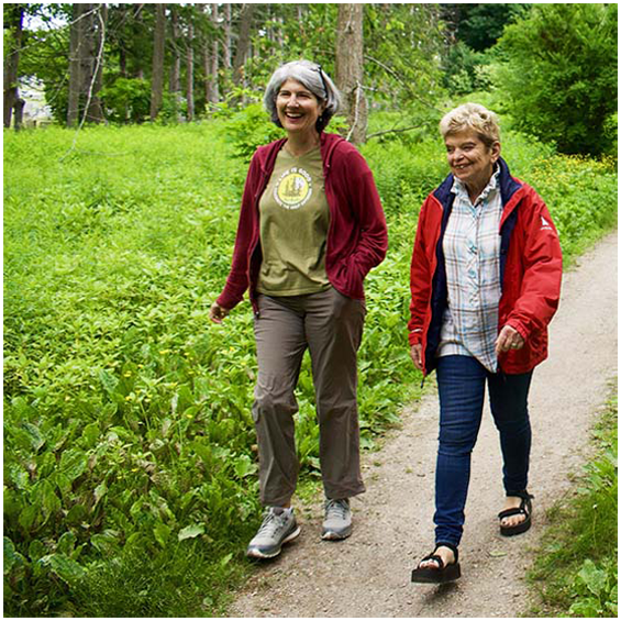 Special Interest Group "Trail Steppers" showing two women walking in the woods