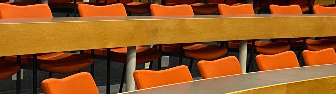 A series of empty chairs in the Wishcamper auditorium.