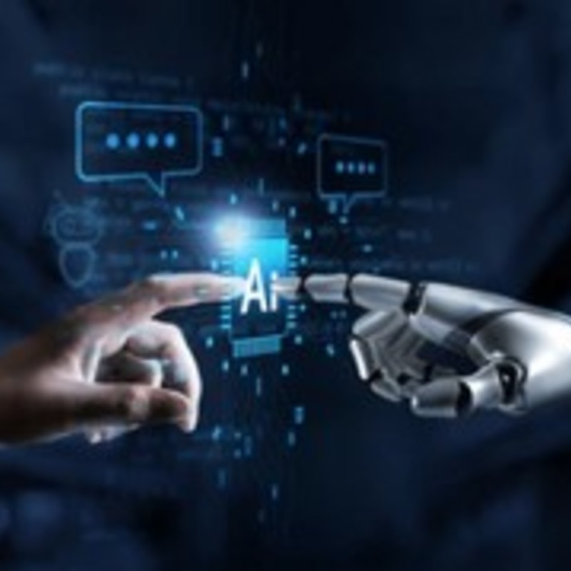 A human hand and a robotic hand touch first fingers.