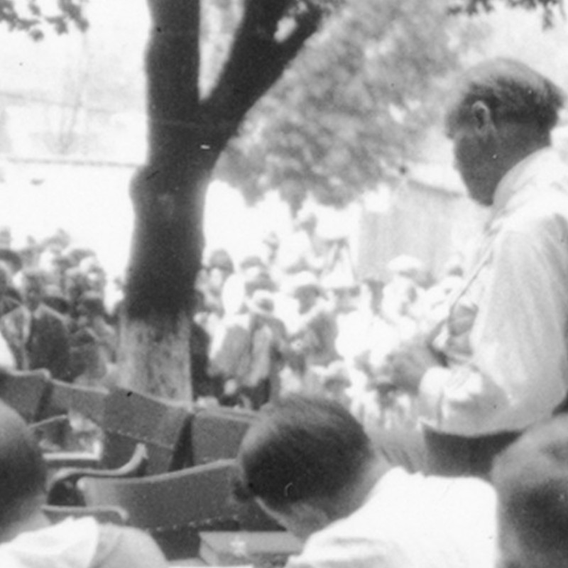 Black and white photo of a crowd outside the trial