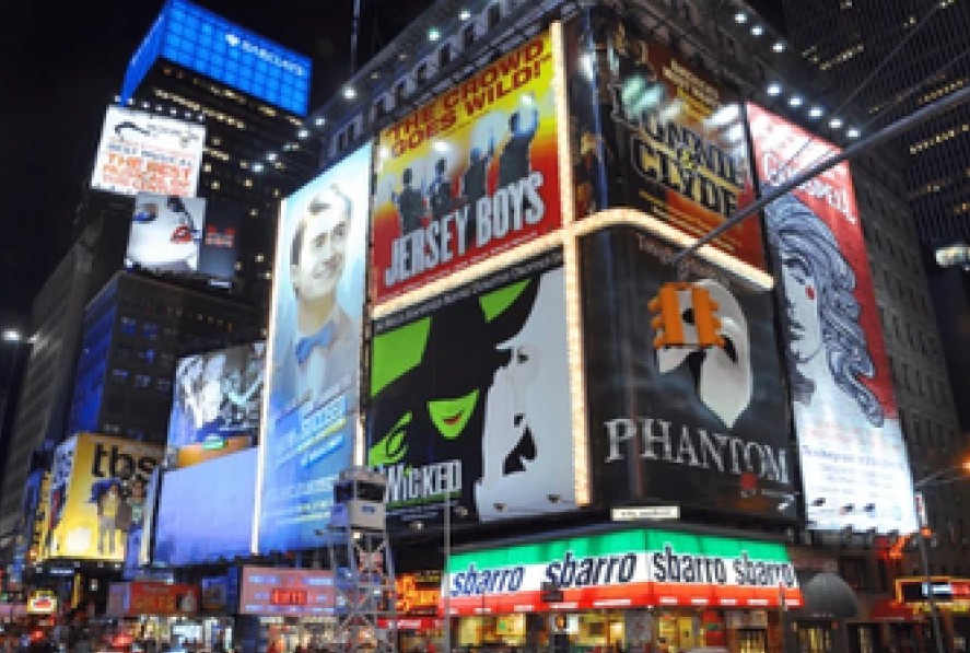 A marquee advertising Broadway musicals including Jersey Boys, Wicked, and Phantom of the Operat.