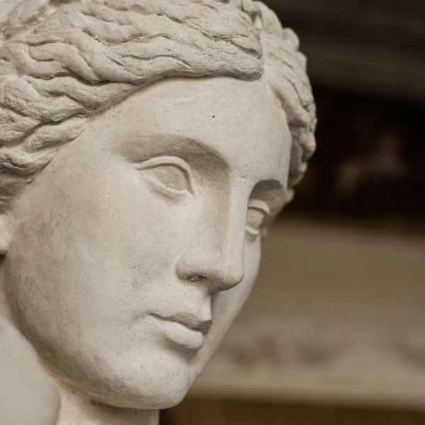 A closeup of a statue of a woman from ancient Greece showing her face.
