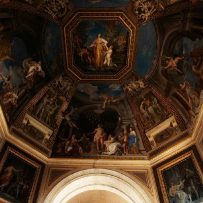 A detailed fresco painting on an octagonal ceiling, depicting mythological scenes.