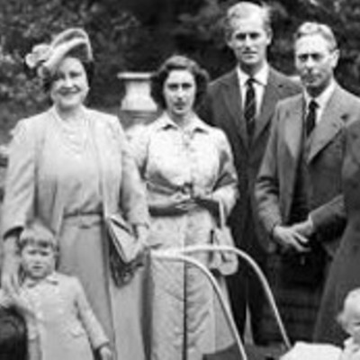 A group portrait of the British Royal Family in a garden setting. Includes Queen Elizabeth II, Prince Philip, and their children.