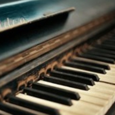 A worn piano keyboard with some of the keys browning.