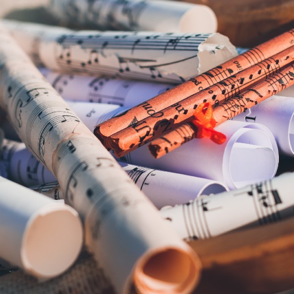 Scrolls of sheet music piled up in a haphazard fashion.