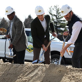 Shovels plunge into the dirt at the groundbreaking ceremony for the new parking garage on the Portland Campus.