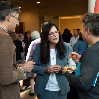 President Jacqueline Edmondson chats with faculty and staff at the 2023 Opening Breakfast buffet.