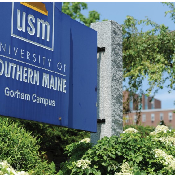 USM Gorham campus entrance sign with summer flowers