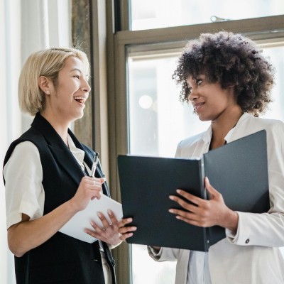 two women talking and laughing business meeting