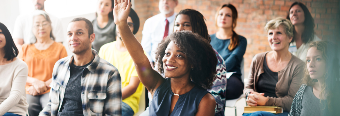 Woman raising her hand in a seminar environment