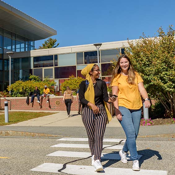 Students crossing a road outside the John Mitchell Center on our Gorham campus.