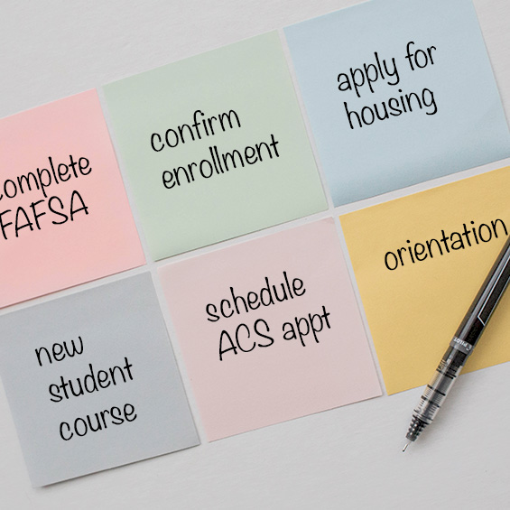 Six different colored sticky notes arranged in a grid pattern with a pen laying across the last one. Clockwise from top left, the notes read: complete FAFSA, confirm enrollment, apply for housing, orientation, schedule ACS appointment, and new student course.