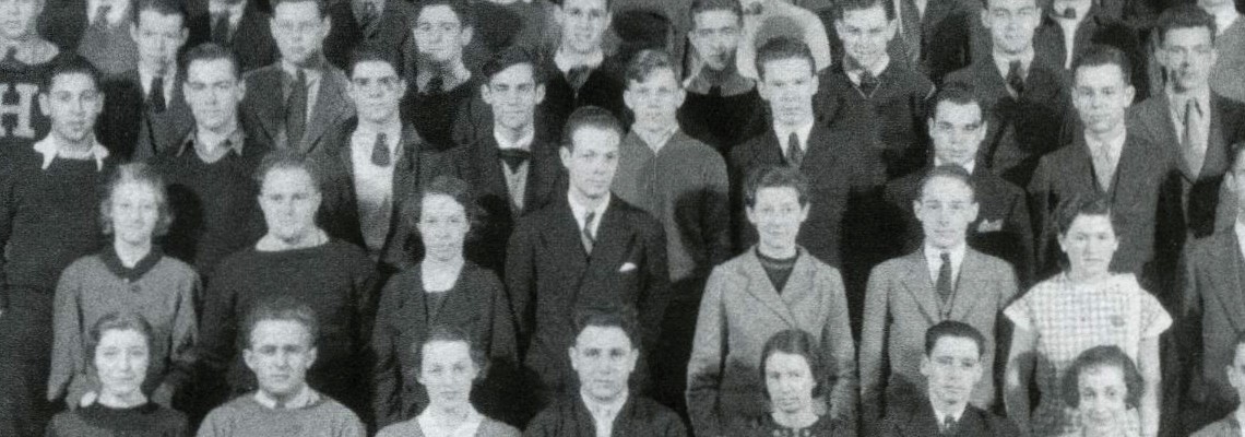 A black and white image of people in a group photo.