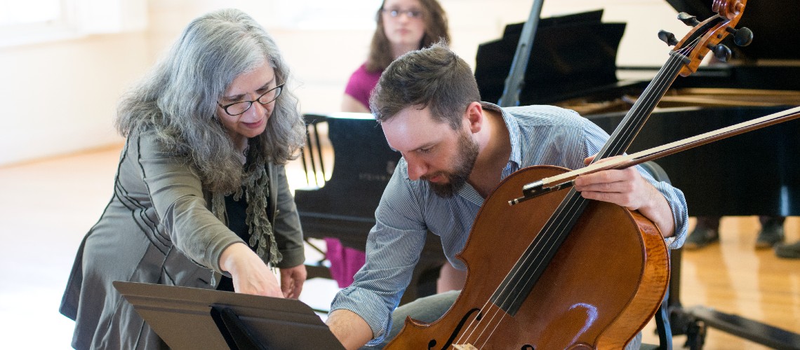 A member of the Music faculty assisting a student