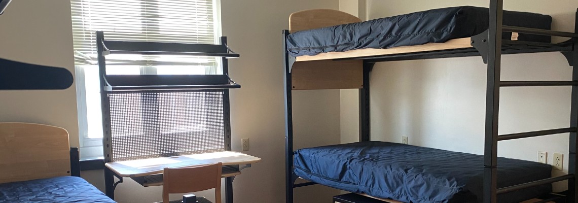 A bunk bed, a single bed and a desk