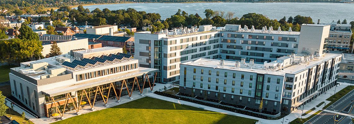 An aerial view that features our McGoldrick Center on the left and our Portland Commons residence hall on the right. Portland's Back Cove appears in the background.