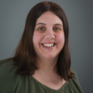 Photo of Lindsay Larsen. Lindsay has brown hair and is wearing a green top.