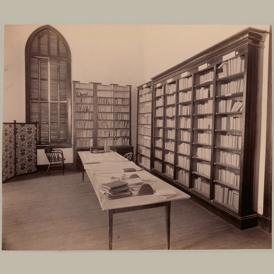 Photograph of library shelves and a display table.