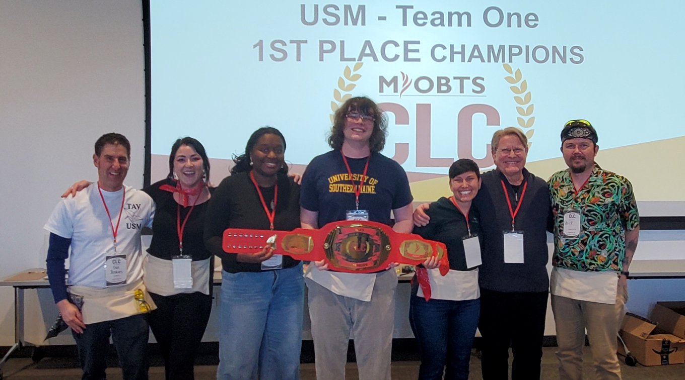 Group picture of the winning team holding the competition prize