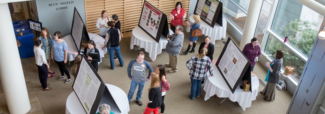 USM students attend a conference featuring tabletop displays.