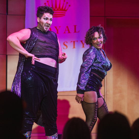 Two drag artists performing together