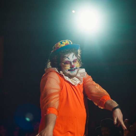 Drag artist in clown-themed drag performing