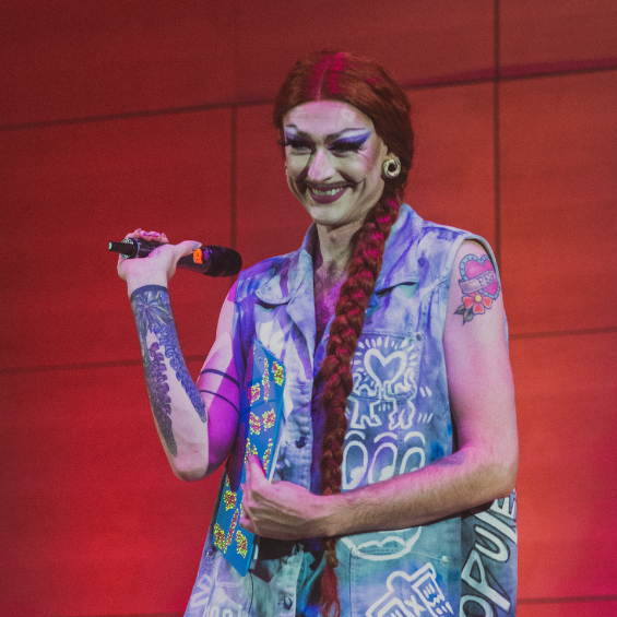 25th Royal Majesty Drag Show Host, Gigi Gabor, standing with mic in hand