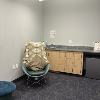 Room with countertop and comfortable chair with blanket