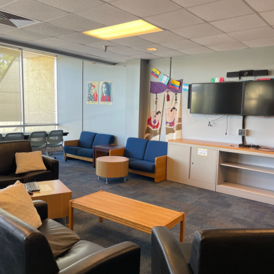 Open space with seating, tvs, and flags hanging on the wall