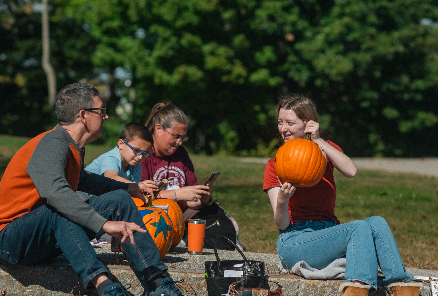Family paints together as part of Fall Fest pumpkin painting, part of USM's Homecoming and Family Weekend