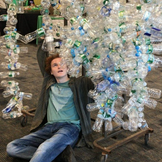 Husky making art out of water bottles.