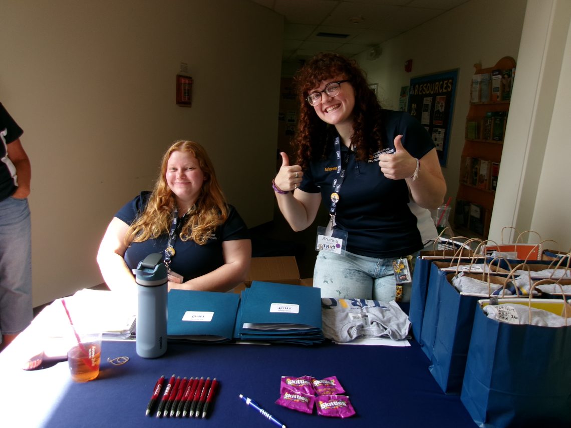 TRIO Peer Leaders pose at a tabling event for new student orientation.