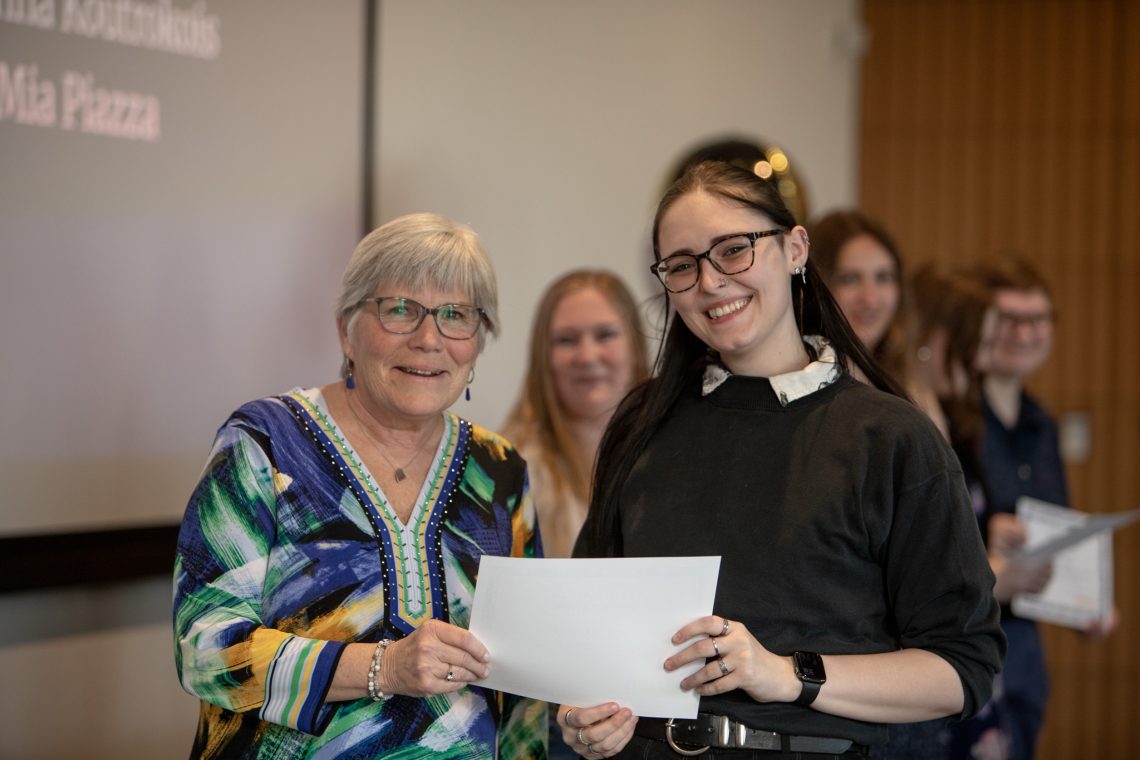 TRIO student and advisor pose at a graduation celebration.